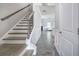 Hallway view featuring wood-look floors, staircase with iron railings, and an open transition to the living space at 158 Bryon Ln, Acworth, GA 30102