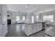 Open-concept kitchen and living space with granite island, stainless steel appliances, and cozy fireplace at 158 Bryon Ln, Acworth, GA 30102
