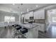 Spacious kitchen island with seating, stainless steel appliances, granite counters, and view to dining area at 158 Bryon Ln, Acworth, GA 30102