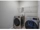 Laundry room features modern washer and dryer with overhead shelving at 158 Bryon Ln, Acworth, GA 30102