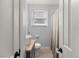 Well-lit bathroom with vessel sink, granite countertop, and tiled shower with curtain at 1649 Beecher Sw St, Atlanta, GA 30310