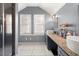 Bathroom with dual vessel sinks, granite countertop, walk-in shower, and natural light at 1649 Beecher Sw St, Atlanta, GA 30310