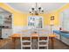 Bright dining room featuring cheerful yellow walls, white trim, and ample natural light at 1649 Beecher Sw St, Atlanta, GA 30310