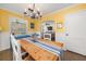 Dining room with a dining table, yellow walls, and access to the living room at 1649 Beecher Sw St, Atlanta, GA 30310