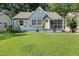 Charming blue home featuring a screened porch and a well-maintained front lawn at 1649 Beecher Sw St, Atlanta, GA 30310