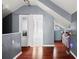 Upstairs hallway with hard wood floors and a sliding barn door at 1649 Beecher Sw St, Atlanta, GA 30310