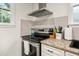 Kitchen with stainless steel appliances, white cabinets, granite countertops, and window at 1649 Beecher Sw St, Atlanta, GA 30310