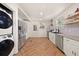 Modern kitchen features stainless steel appliances, herringbone floors, and ample cabinet space at 1649 Beecher Sw St, Atlanta, GA 30310