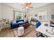 Inviting living room with a blue couch, hardwood floors, rug, and natural light from windows at 1649 Beecher Sw St, Atlanta, GA 30310