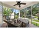 Screened-in porch with brick flooring, ceiling fan, and outdoor furniture at 1649 Beecher Sw St, Atlanta, GA 30310