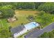 Aerial view of community pool, playground and lake surrounded by lush greenery and mature trees at 1867 N Creek Cir, Alpharetta, GA 30009