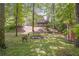 Spacious backyard with a firepit, steps leading to the house, and a storage shed at 1867 N Creek Cir, Alpharetta, GA 30009