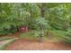 Lush backyard featuring mature trees, green space, and a small shed for storing lawn equipment at 1867 N Creek Cir, Alpharetta, GA 30009