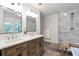 Bright bathroom with double vanity, large mirrors, a walk-in shower, and a freestanding tub at 1867 N Creek Cir, Alpharetta, GA 30009