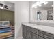 Bathroom featuring a vanity, framed mirror, and a door to the bedroom at 1867 N Creek Cir, Alpharetta, GA 30009
