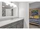 Bathroom featuring a vanity, framed mirror, and a tiled shower at 1867 N Creek Cir, Alpharetta, GA 30009