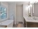 Luxurious bathroom featuring a freestanding tub, stylish fixtures, and double sink vanity with ample counter space at 1867 N Creek Cir, Alpharetta, GA 30009