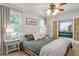 Comfortable bedroom featuring a ceiling fan, two windows, neutral bedding, and an attractive dresser at 1867 N Creek Cir, Alpharetta, GA 30009