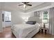 Serene bedroom suite with tray ceiling, ensuite bathroom, and large window view at 1867 N Creek Cir, Alpharetta, GA 30009