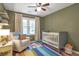 Cozy Bedroom with crib, soft chair, and colorful rug for a playful space at 1867 N Creek Cir, Alpharetta, GA 30009