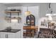 Bright kitchen features floating shelves, gas range, and eating area with pendant lighting at 1867 N Creek Cir, Alpharetta, GA 30009