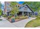 Exterior shot of Holmes restaurant, featuring a covered porch and beautiful landscaping at 1867 N Creek Cir, Alpharetta, GA 30009