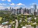 Aerial view showcasing the city skyline and lush green trees surrounding the neighborhood at 281 15Th Ne St # 202, Atlanta, GA 30309