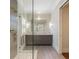 Modern bathroom featuring a glass shower, gray vanity with marble countertop, and neutral tile flooring at 281 15Th Ne St # 202, Atlanta, GA 30309