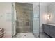 Bathroom featuring a glass-enclosed shower with multiple showerheads, and gray vanity with marble countertop at 281 15Th Ne St # 202, Atlanta, GA 30309