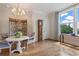 Cozy dining area featuring hardwood floors, a chandelier, and a large window that lets in great natural light at 281 15Th Ne St # 202, Atlanta, GA 30309