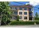Modern condo building featuring balconies, awnings, and a landscaped front yard at 281 15Th Ne St # 202, Atlanta, GA 30309
