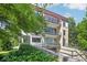 Beautiful condo featuring a red metal roof and multi-level balconies surrounded by mature landscaping at 281 15Th Ne St # 202, Atlanta, GA 30309