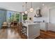 Open kitchen with stone countertops, stainless appliances, and hardwood floors, adjacent to a casual sitting area at 281 15Th Ne St # 202, Atlanta, GA 30309