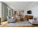 Bright living room showcasing hardwood floors, large windows, and an open layout connected to the kitchen at 281 15Th Ne St # 202, Atlanta, GA 30309