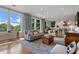 Open-concept living room flows into the kitchen with hardwood floors and oversized windows with natural light at 281 15Th Ne St # 202, Atlanta, GA 30309
