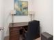 Home office setup with a classic wooden desk, comfortable chair, and elegant lamps at 281 15Th Ne St # 202, Atlanta, GA 30309