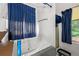 Bathroom featuring a bathtub with blue curtains and a separate shower at 1394 Isleworth Cir, Atlanta, GA 30349