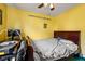 Bedroom with a desk, bed, and yellow walls, under a happy birthday banner at 1394 Isleworth Cir, Atlanta, GA 30349