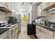 Functional kitchen featuring essential appliances, laminate countertop, and ample storage at 1394 Isleworth Cir, Atlanta, GA 30349