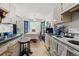 Cozy kitchen featuring white appliances and cabinets plus a dining area near a glass door at 1394 Isleworth Cir, Atlanta, GA 30349