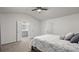 Bright bedroom featuring a ceiling fan, a bed, and access to bathroom at 147 Townview Dr, Woodstock, GA 30189