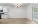 Open dining area with stainless steel appliances, a chandelier, and backyard access at 147 Townview Dr, Woodstock, GA 30189