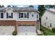 Two-story townhome featuring a brick and siding facade with an attached two-car garage at 147 Townview Dr, Woodstock, GA 30189