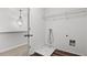 Bright laundry room featuring connections, flooring, and a convenient wire shelf at 147 Townview Dr, Woodstock, GA 30189