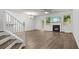 Open living room featuring wood floors, fireplace, and large windows that provide natural light at 147 Townview Dr, Woodstock, GA 30189