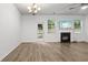 Living room features a fan, fireplace, and door that provides access to backyard area at 147 Townview Dr, Woodstock, GA 30189