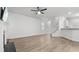 Open living room with fireplace, adjacent stairs, and a view into the kitchen at 147 Townview Dr, Woodstock, GA 30189