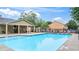 Community pool with pool furniture and a covered structure with tables and chairs at 147 Townview Dr, Woodstock, GA 30189