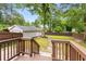 View of a spacious fenced backyard with a wooden deck, green grass and a detached garage at 1927 Alexander Se St, Smyrna, GA 30080