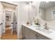 Modern bathroom with double vanity, gray cabinets, white countertops, and oval mirrors at 1927 Alexander Se St, Smyrna, GA 30080
